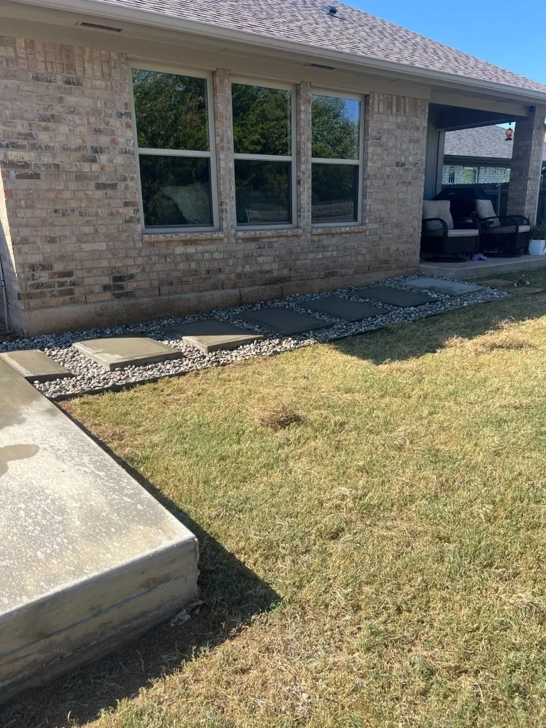 Concrete paver walkway in river rock running from the covered porch to a new concrete patio in Norman, OK