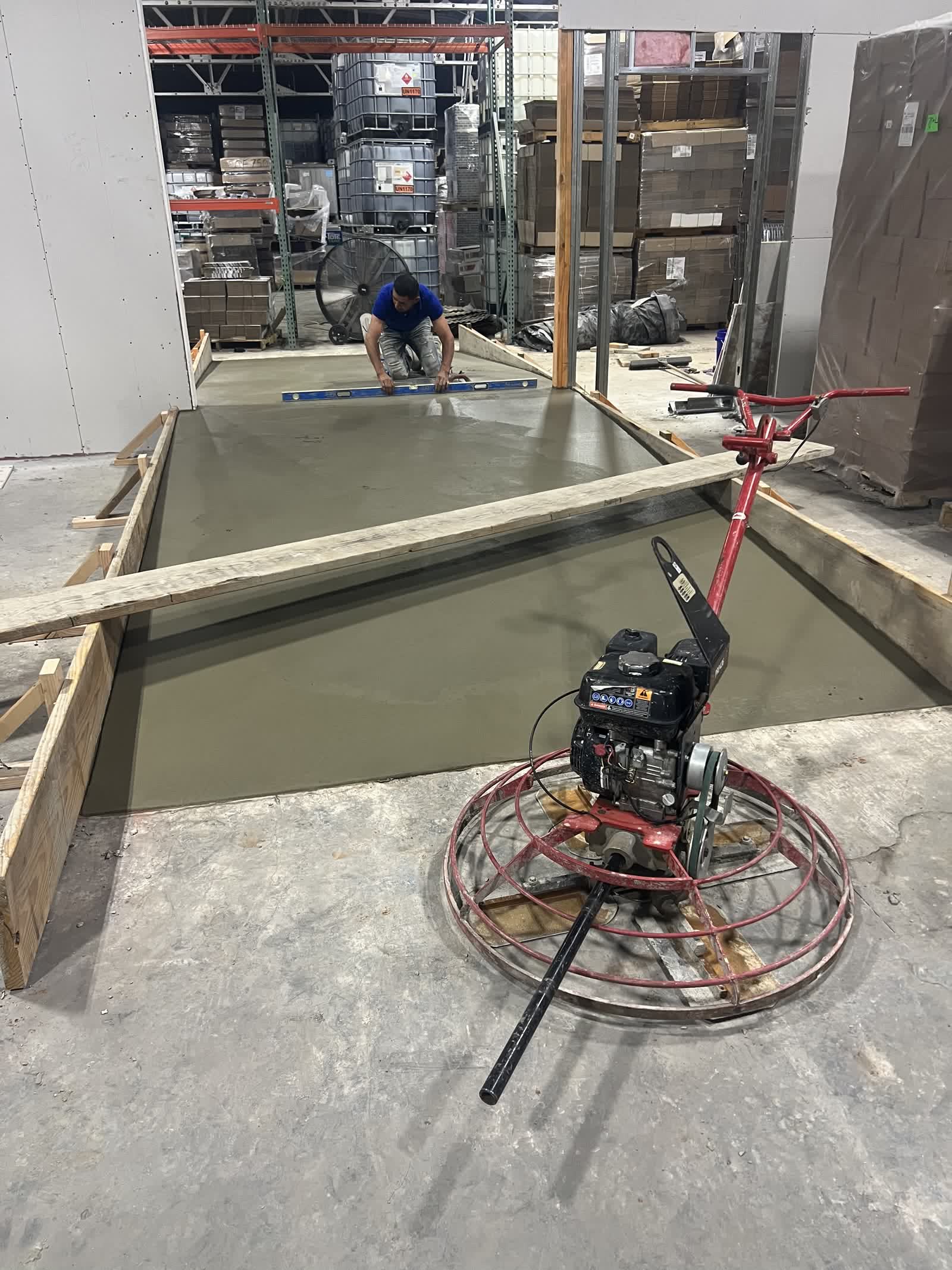 Power trowel finishing a concrete forklift ramp pour inside a warehouse in Guthrie, Oklahoma