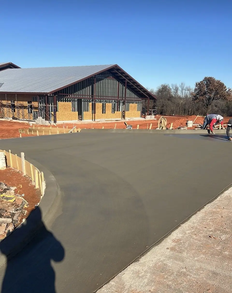 New 6-inch thick, 24-foot wide concrete driveway and approach being finished by the FDZ Construction crew